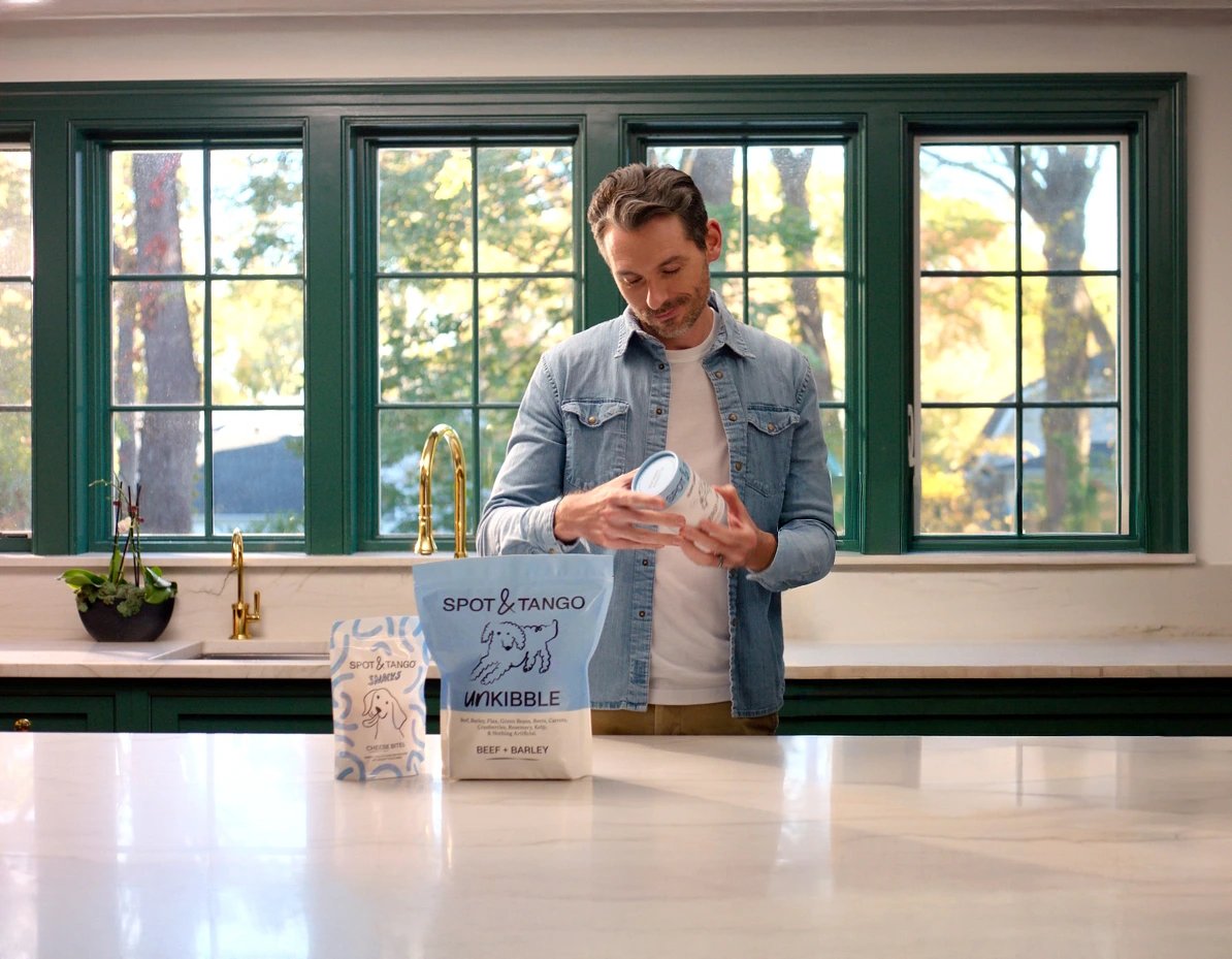 Man scooping UnKibble in his kitchen